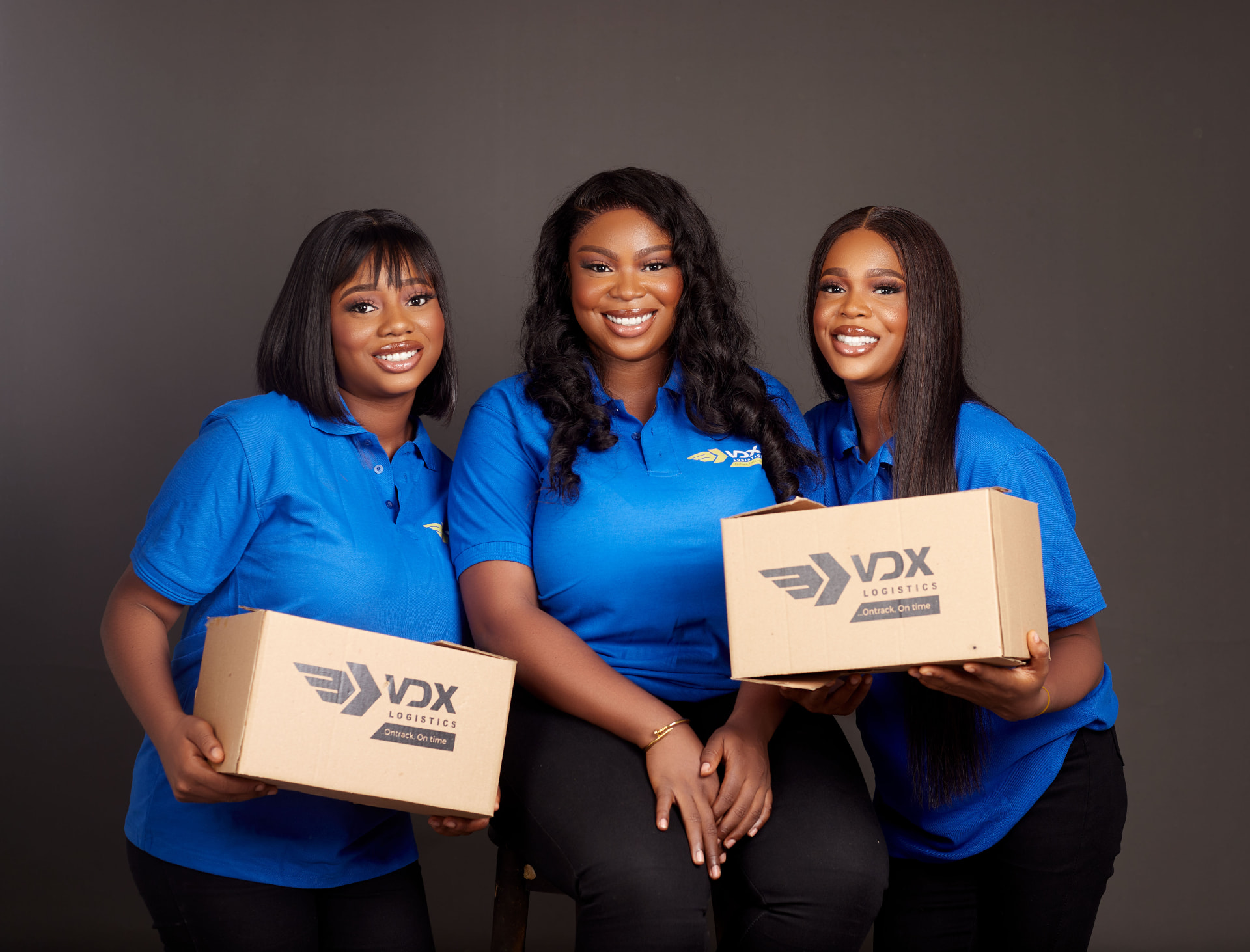 VDX Logistics team in branded shirts holding VDX delivery boxes